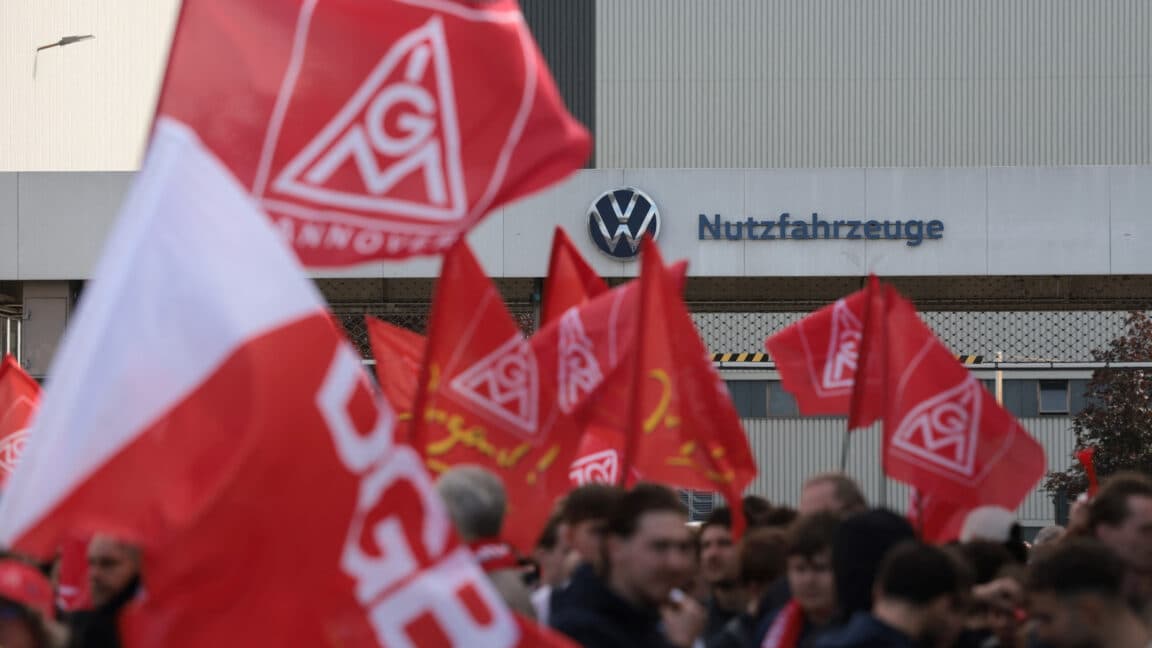 Automotive workers protesting in Germany, demanding job security and corporate accountability.