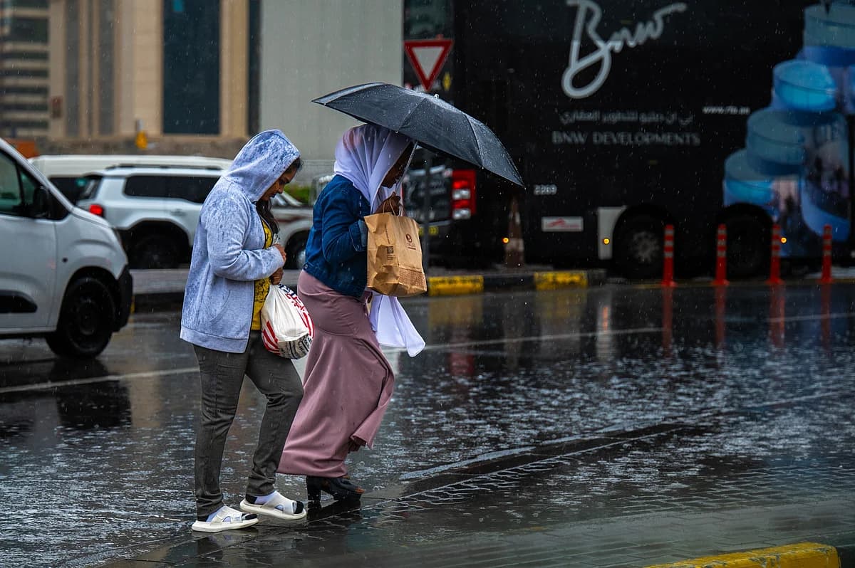A dramatic image showing contrasting weather conditions in the UAE with heat and rain.