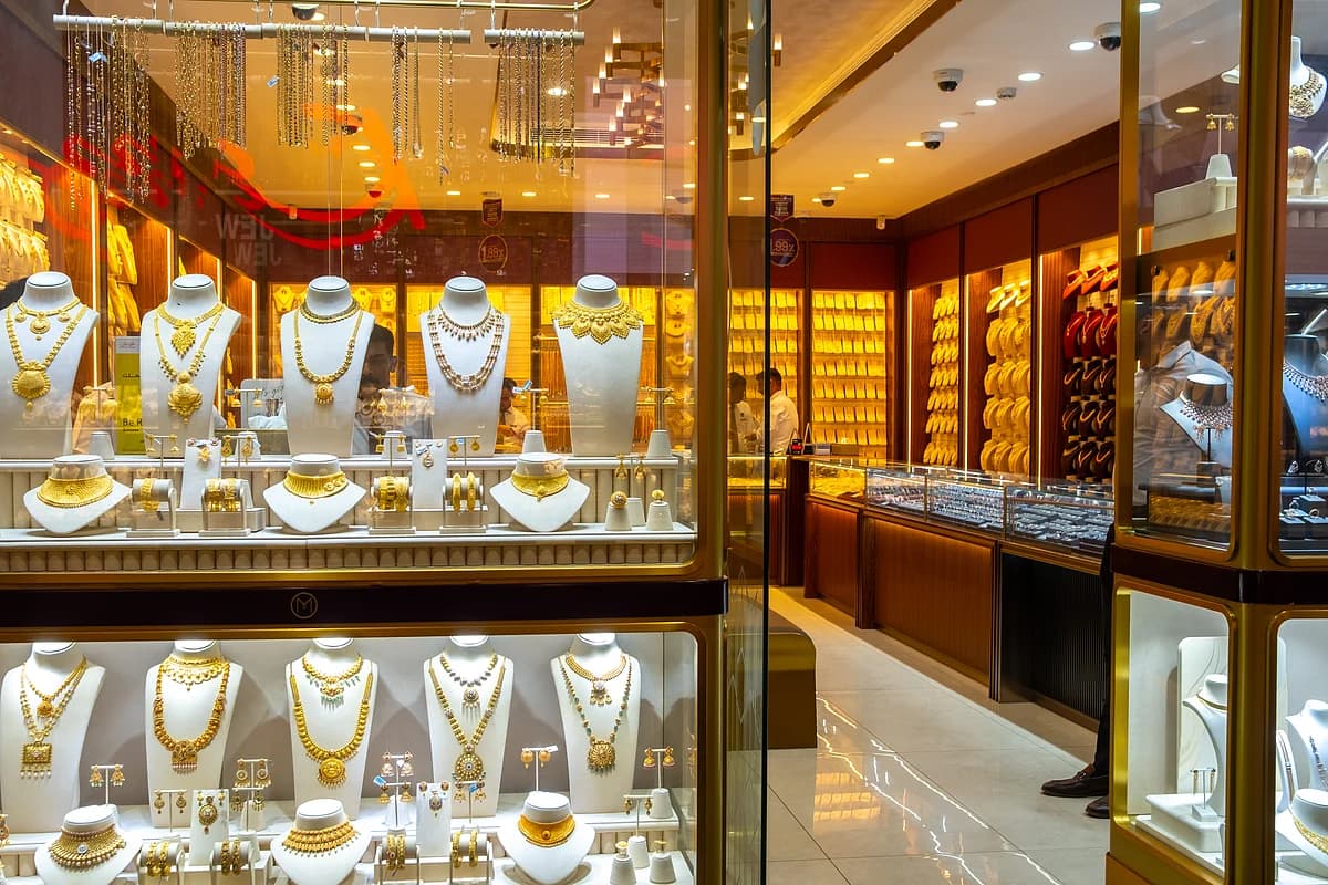 Gold bars with fluctuating price graphs in the background