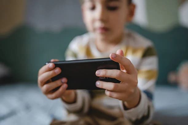 Children using social media responsibly under new UAE regulations.