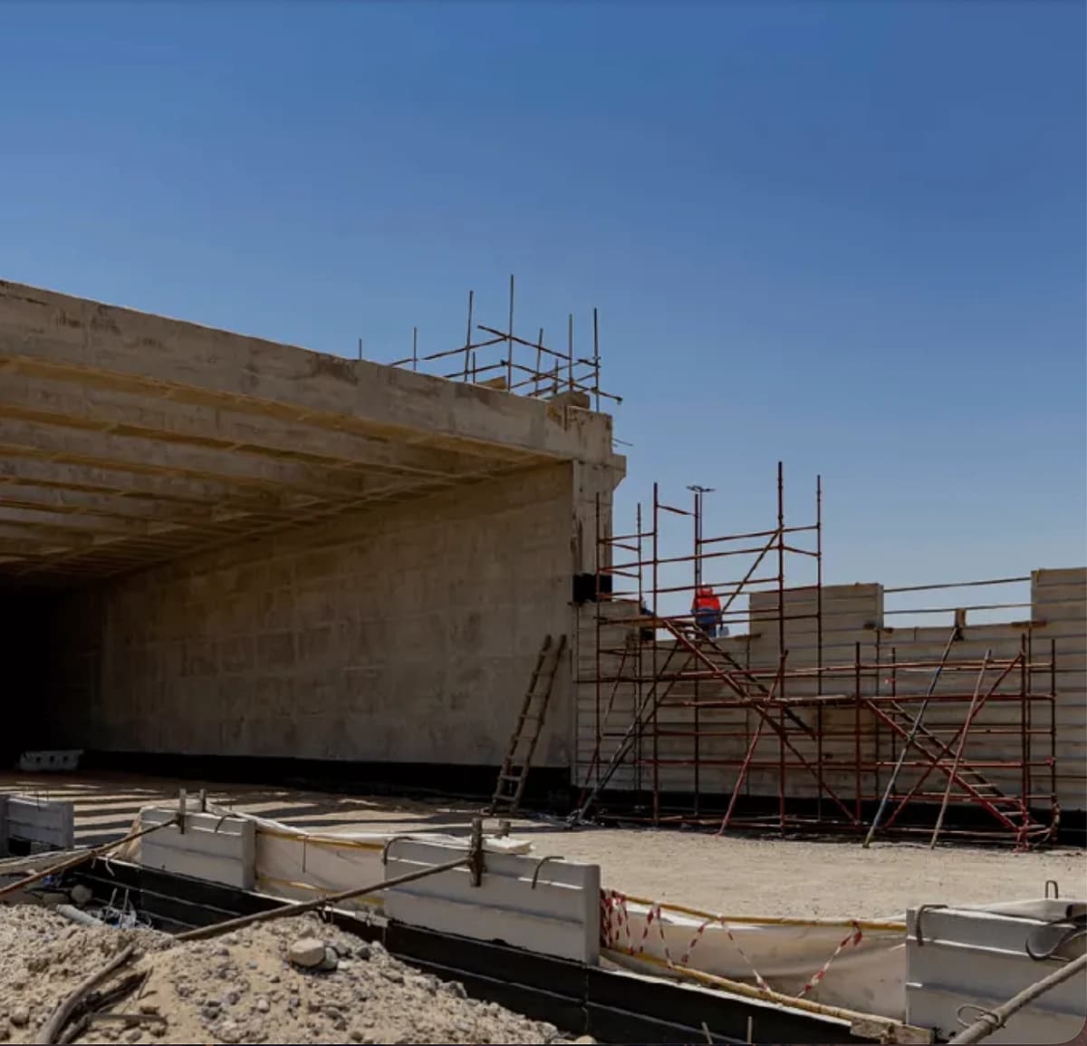 Aerial view of the E20 highway in Abu Dhabi with construction plans.