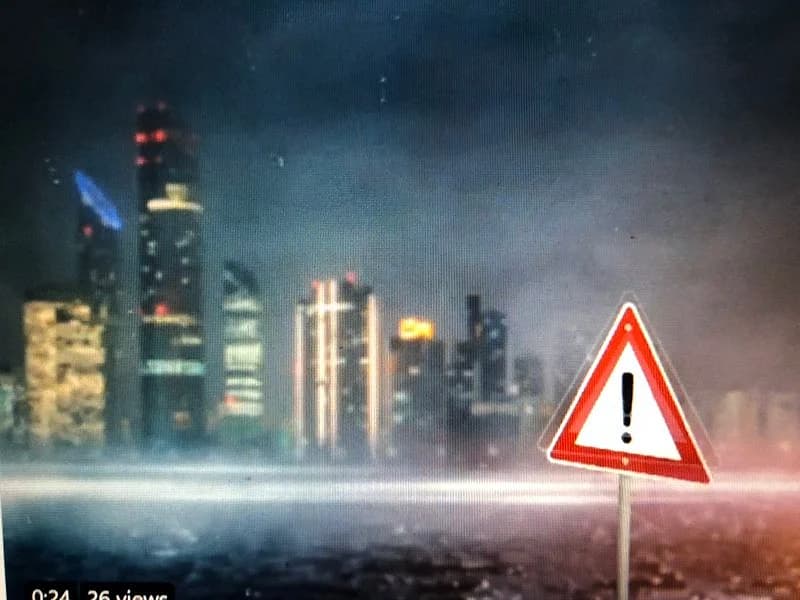Sleek dark asphalt highway during rainfall with glowing white text advising driver safety in the UAE