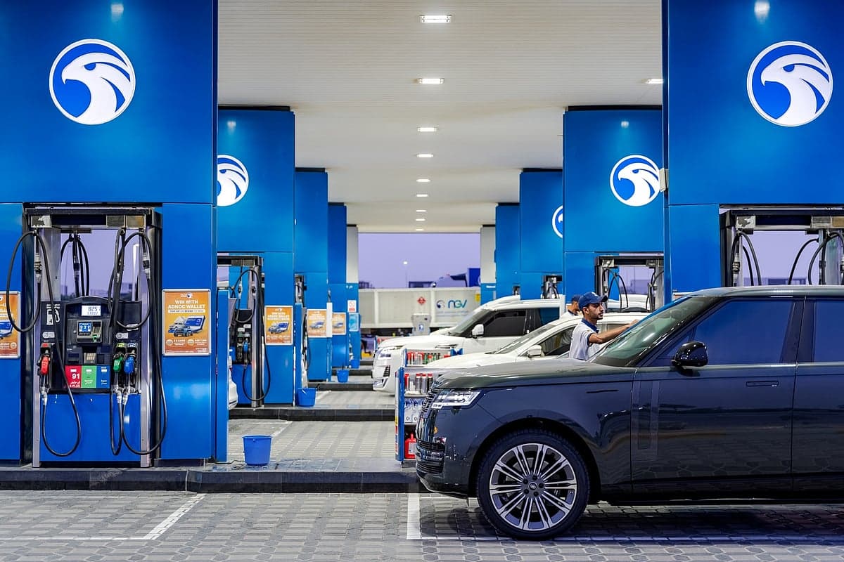 ADNOC Distribution logo with fuel stations in South Africa background