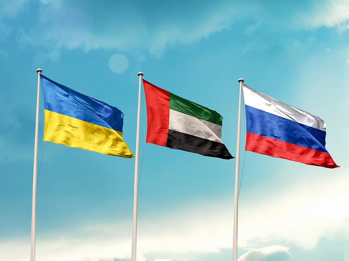Ukrainian and Russian flags with a backdrop of a peace negotiation scene.