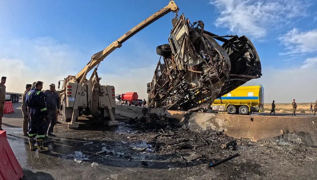 Scene of the bus accident in southern Iraq with emergency responders at the site.