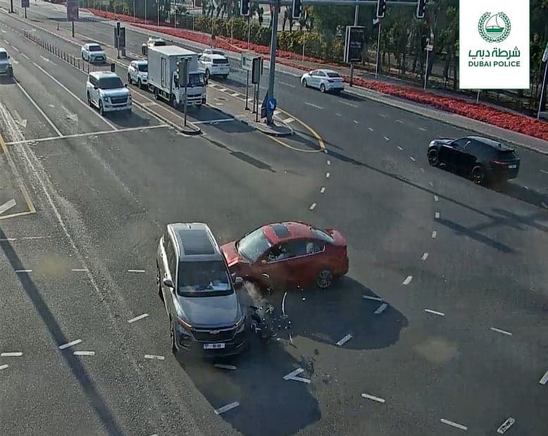 Traffic light with a red signal in Dubai, highlighting road safety concerns.