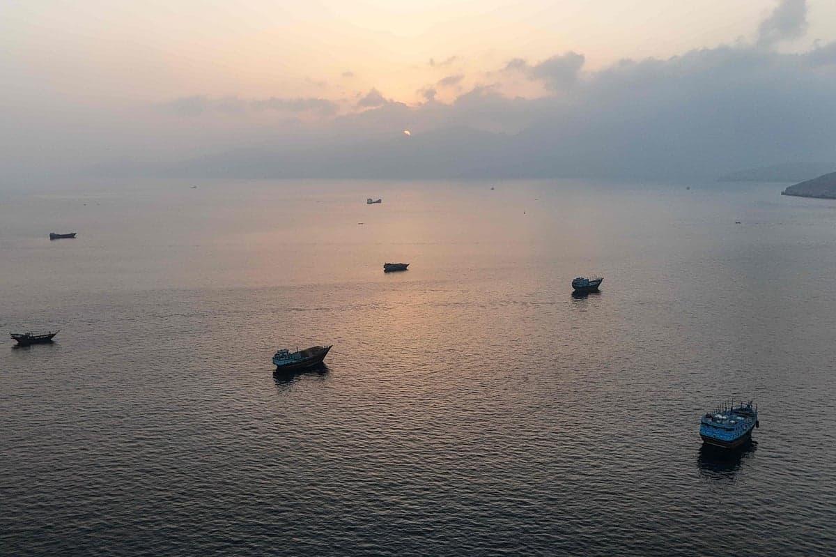 Shipping vessels navigating the Strait of Hormuz amidst safety concerns.