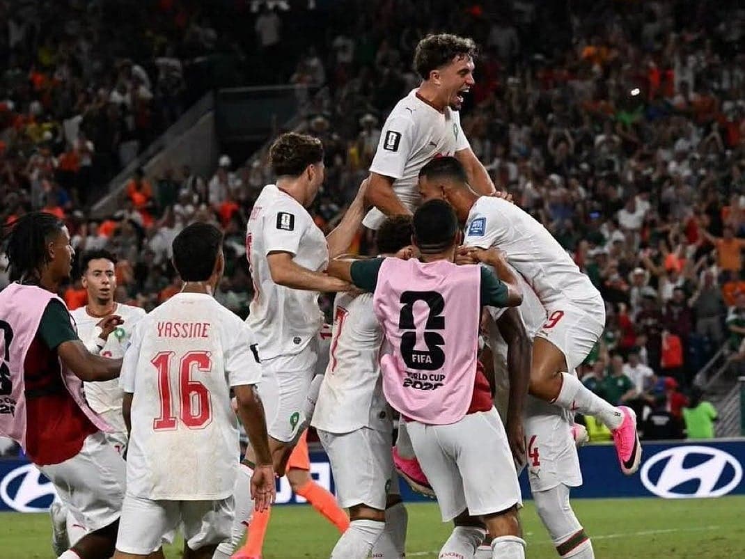 Moroccan football team celebrating their qualification for the World Cup Round of 16.
