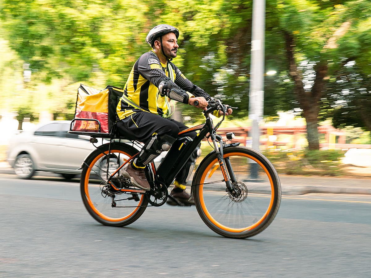 Electric bicycles in Dubai's urban landscape for delivery services.