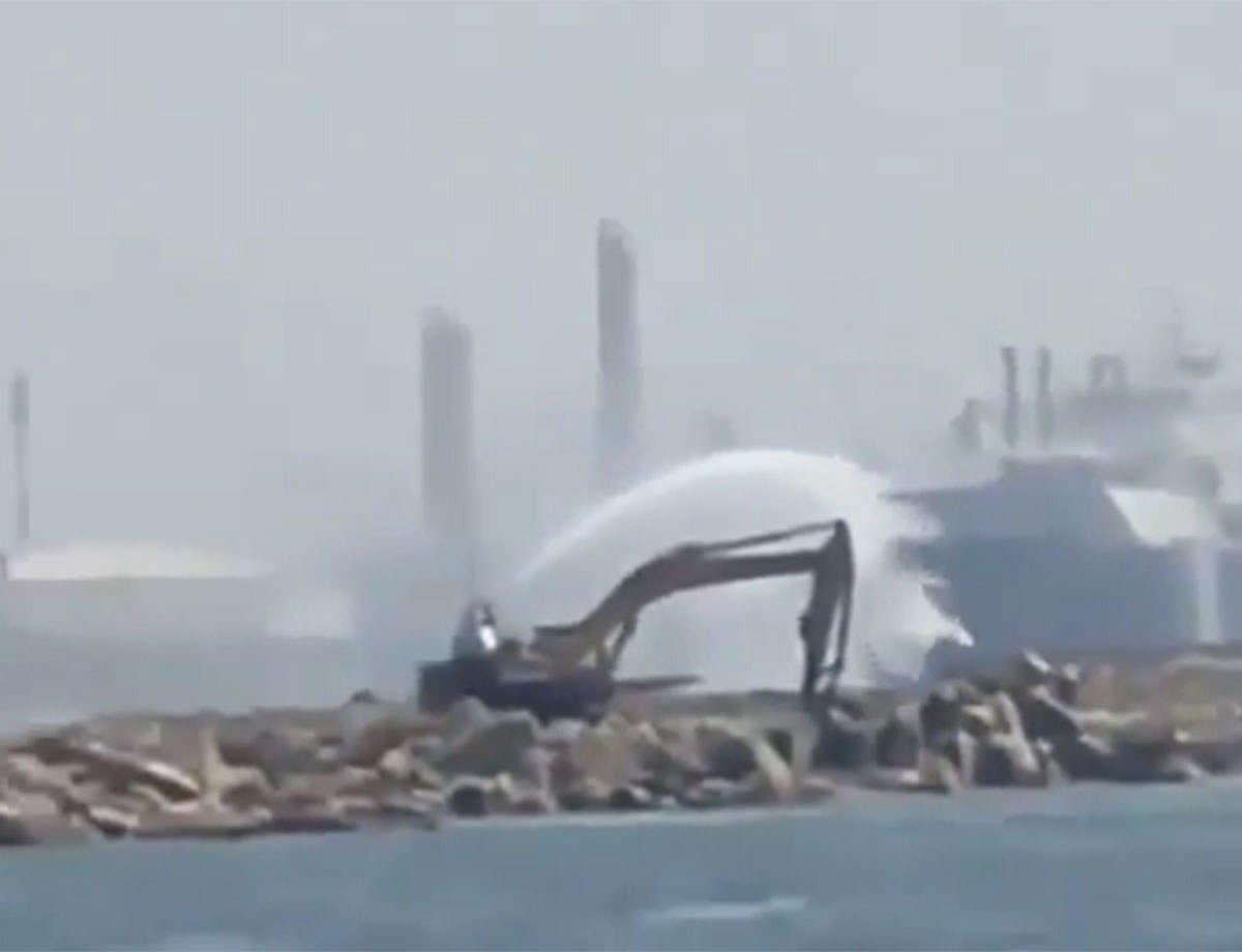 Aerial view of Damietta port with smoke rising from a fire.