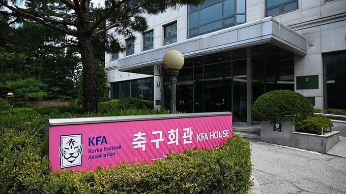 South Korea Football Association logo with a backdrop of a football field