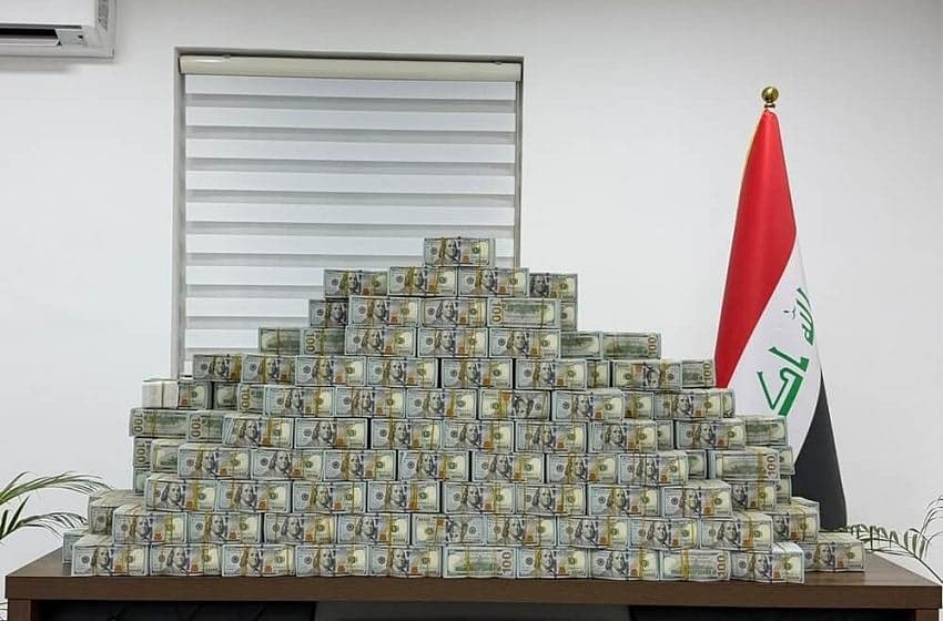 Iraqi authorities display seized gold and cash linked to corruption case.
