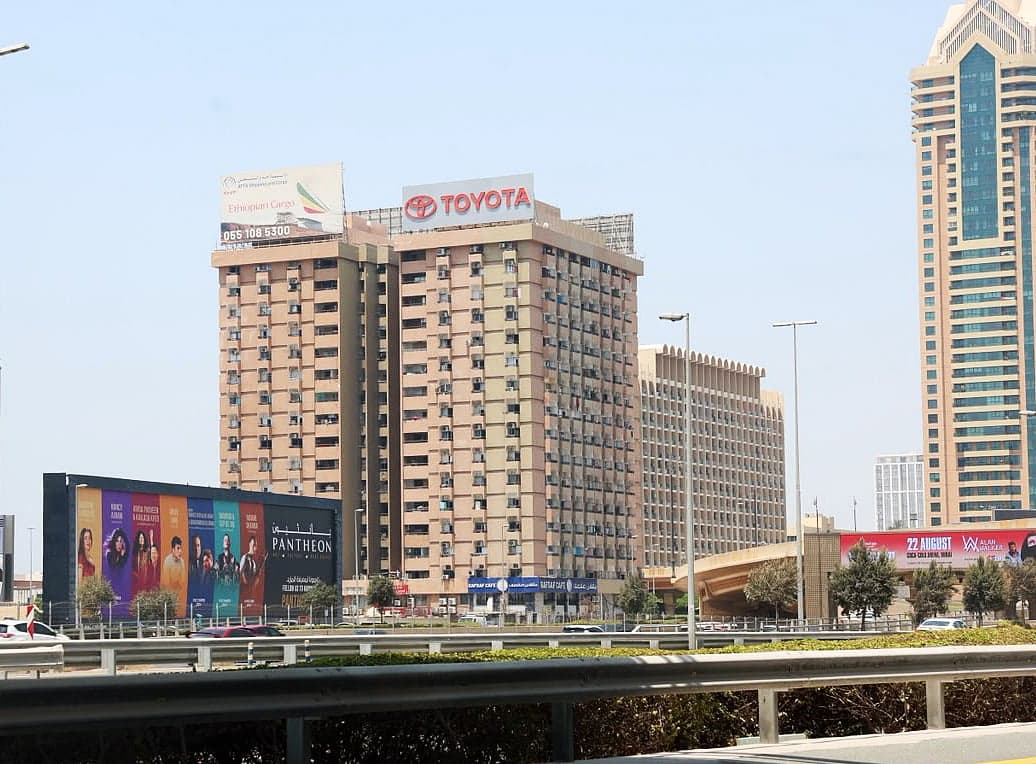 An infographic depicting the history and significance of Dubai's Toyota Building, highlighting its upcoming demolition and impact on housing.