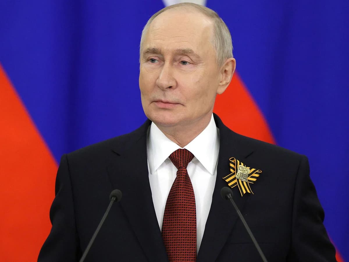 Vladimir Putin speaking during an interview, addressing European war warnings and upcoming trilateral talks.