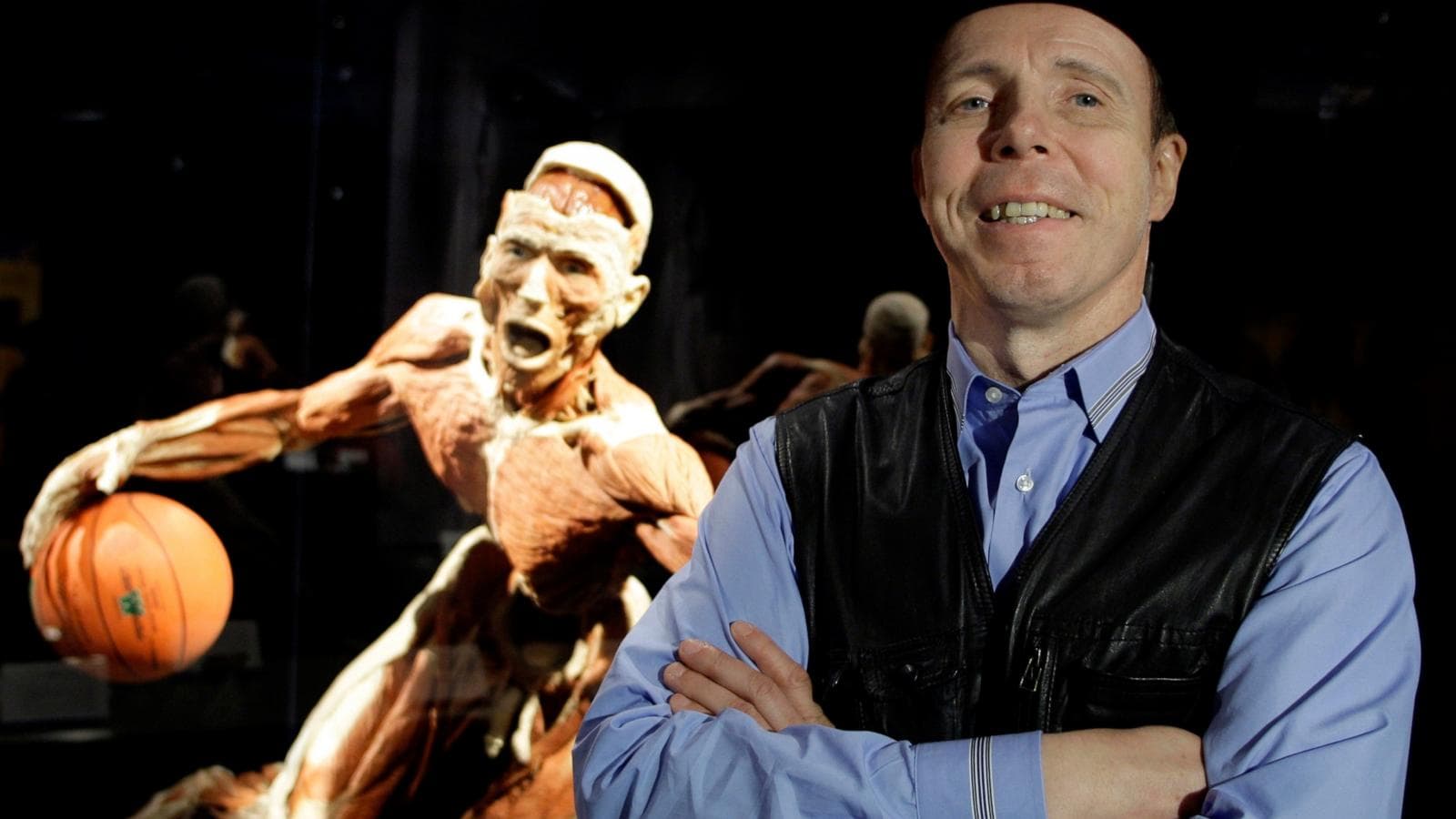 Gunther von Hagens at a Body Worlds exhibition showcasing plastinated bodies.