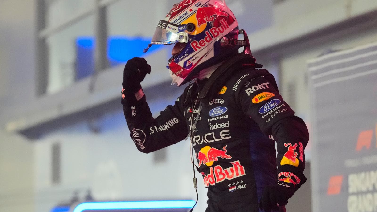 Max Verstappen celebrating his first victory at the Singapore Grand Prix, showcasing his dominance in Formula 1.