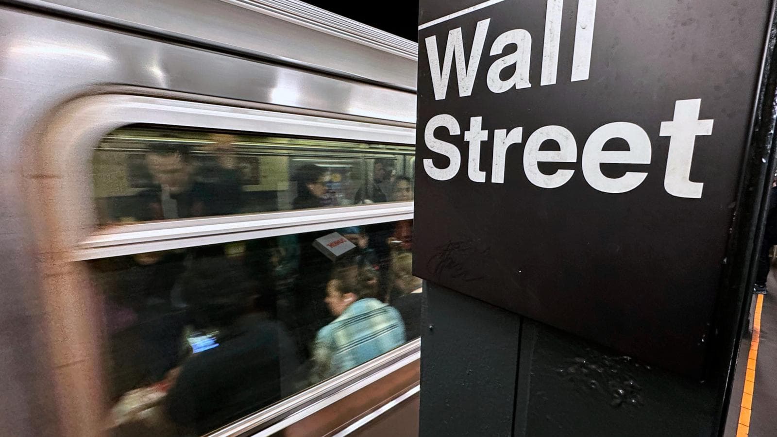U.S. and Iran flags with oil barrels and stock market graphs