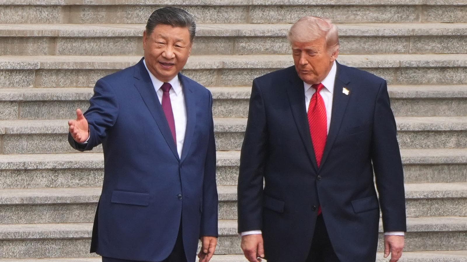 Xi Jinping and Donald Trump shaking hands during the 2026 state visit, highlighting U.S.-China relations.