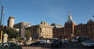 South African Revenue Service building with cryptocurrency symbols