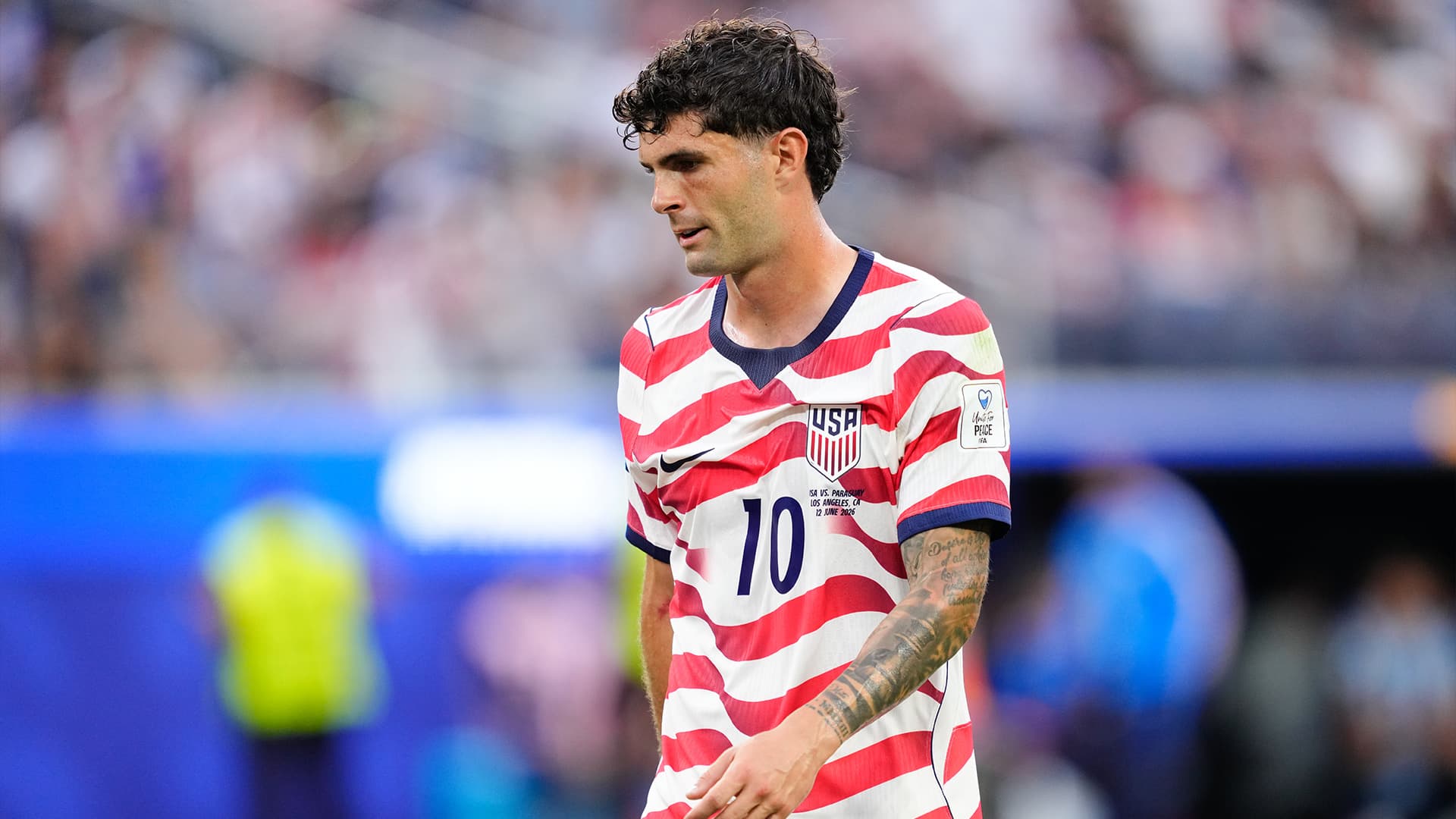 Christian Pulisic celebrating during the USMNT's World Cup match against Paraguay.