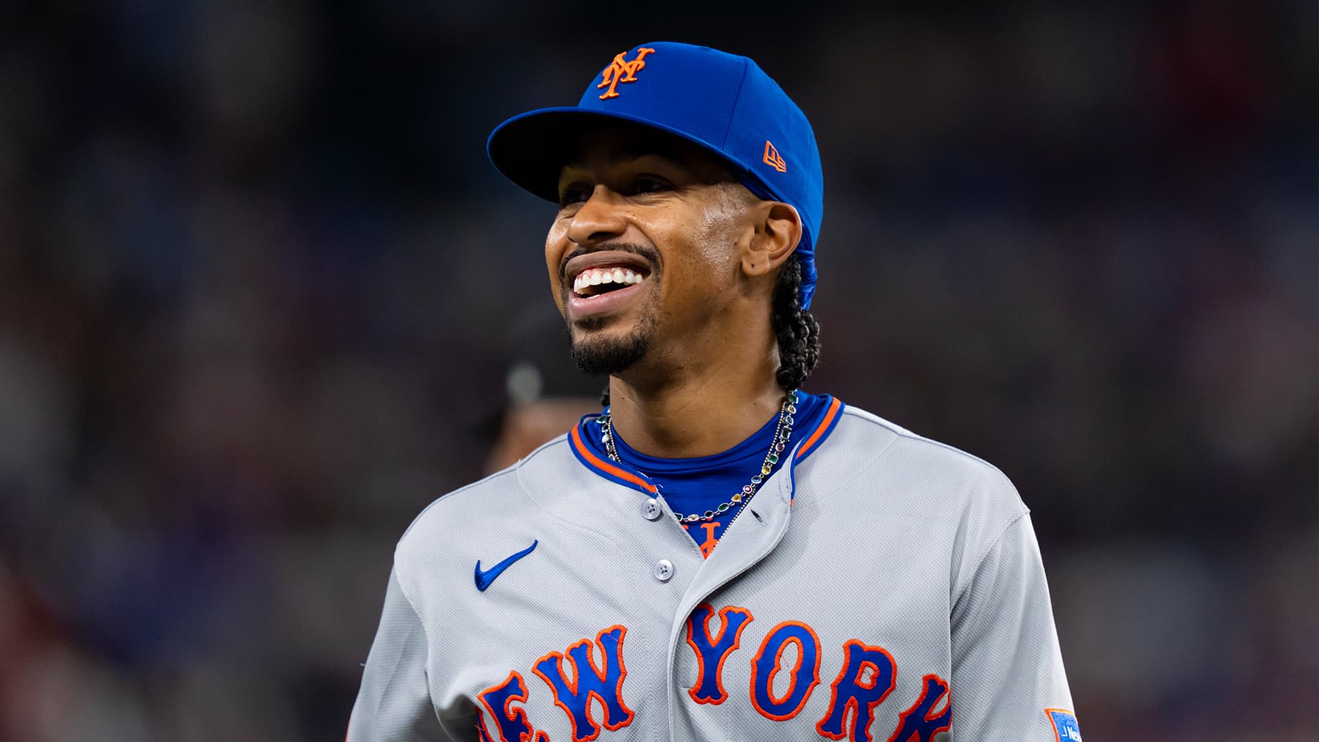 Francisco Lindor of the New York Mets receives the 2026 Roberto Clemente Award trophy on field.