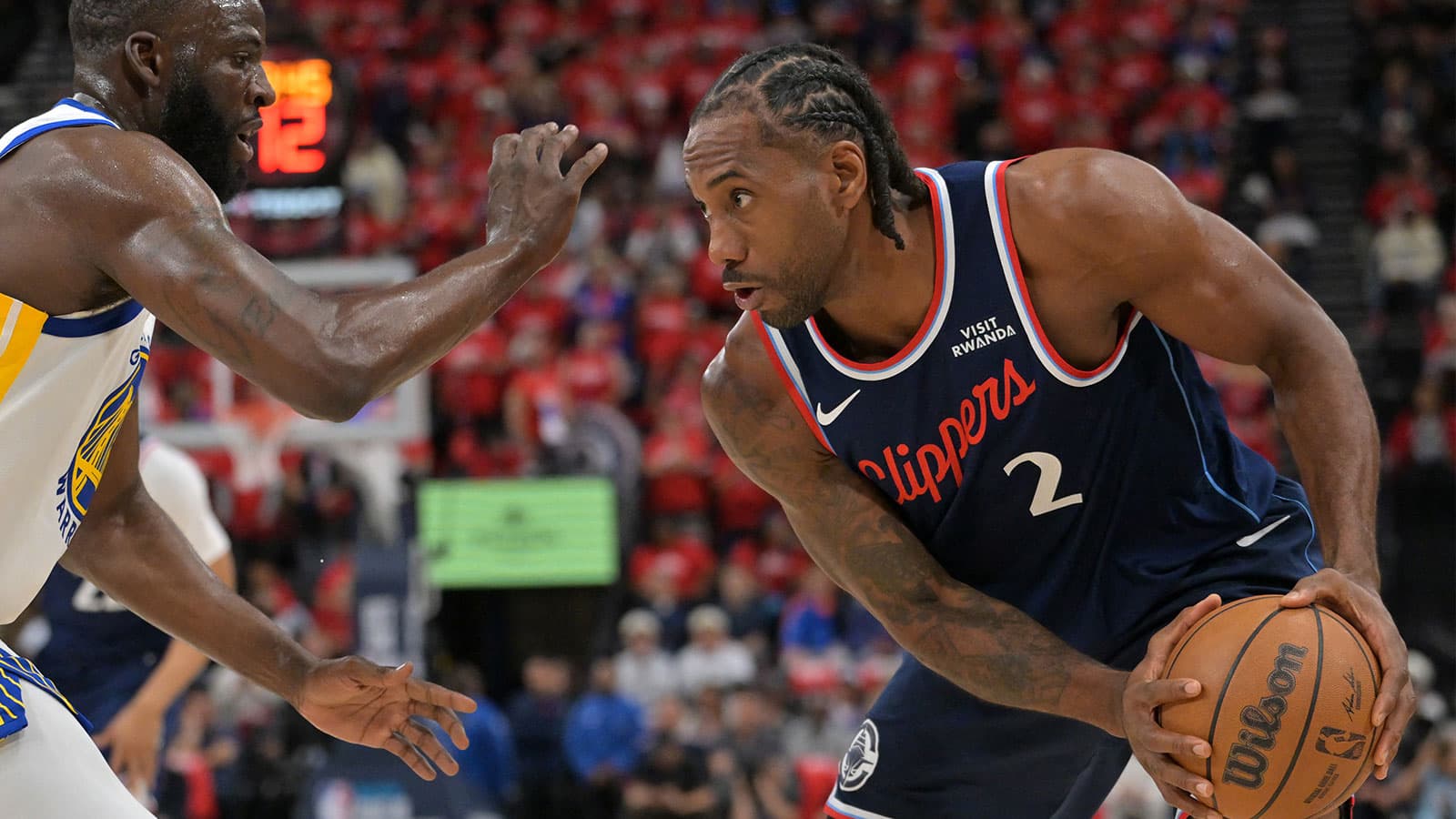Kawhi Leonard during a game, with Clippers logo in the background.