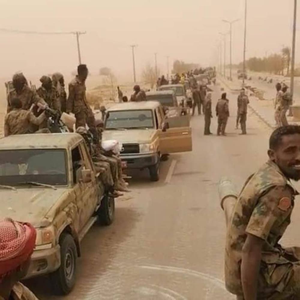 U.S. Congress building with a backdrop of Sudan's conflict imagery.