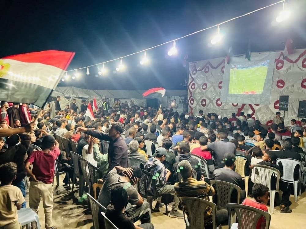 Residents of Gaza watching the World Cup on makeshift screens.
