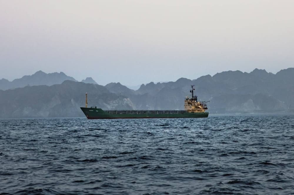 U.S. and Iran flags with military imagery in the background