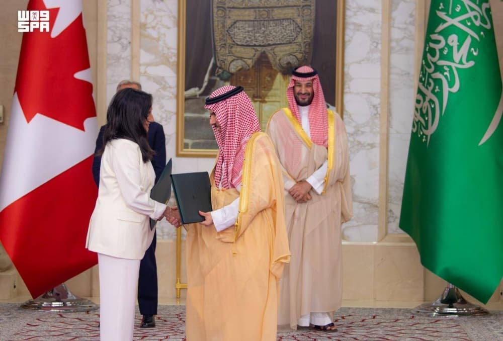 Saudi and Canadian officials shaking hands during a meeting in Jeddah.