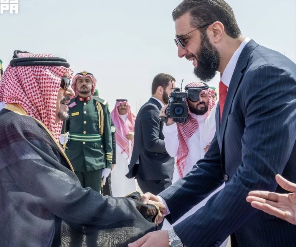 President Al-Sharaa and Crown Prince Mohammed bin Salman shaking hands during a diplomatic meeting in Riyadh.