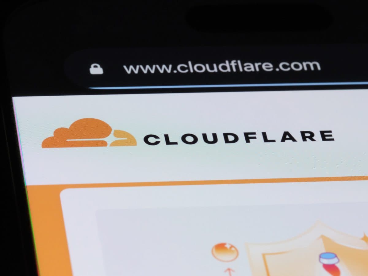 Cloudflare logo with a digital landscape background
