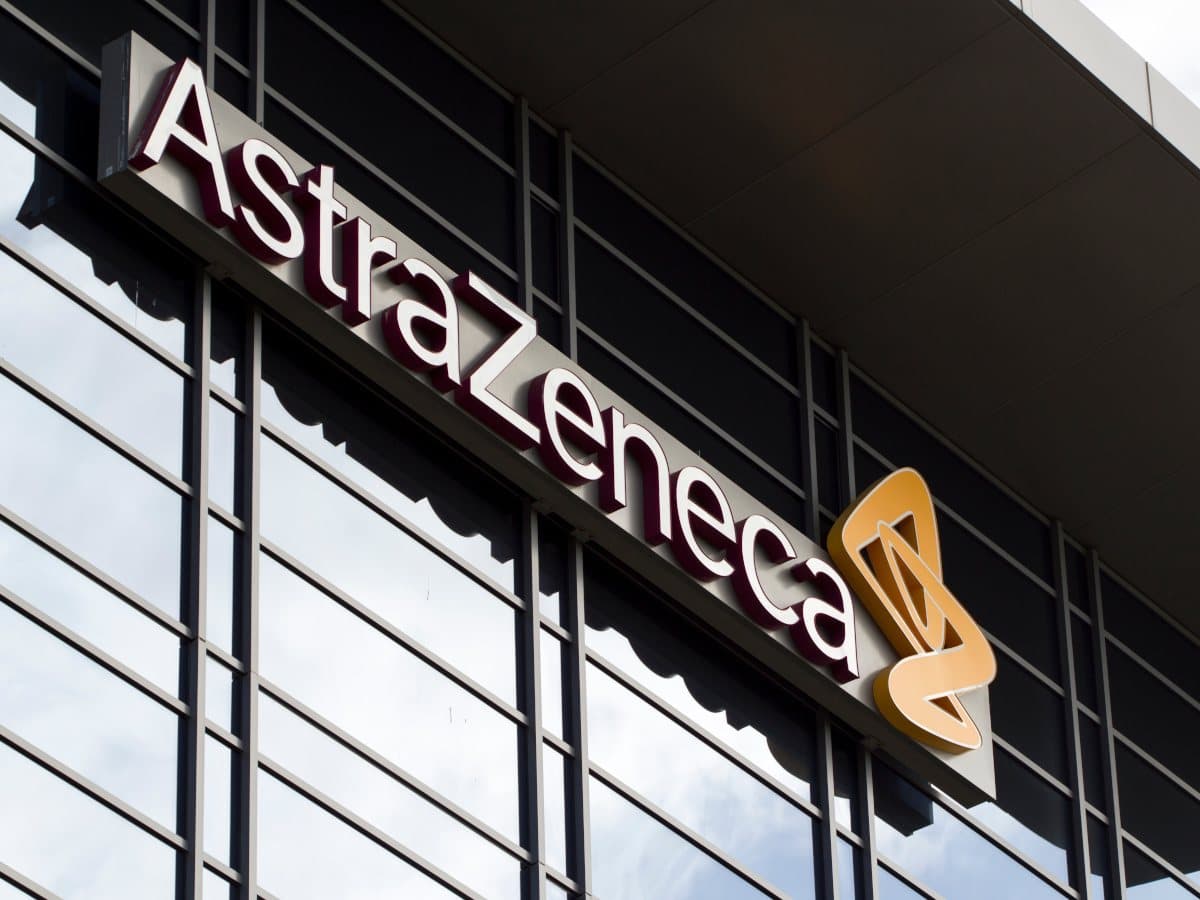 AstraZeneca and Bristol Myers Squibb logos with a financial market background