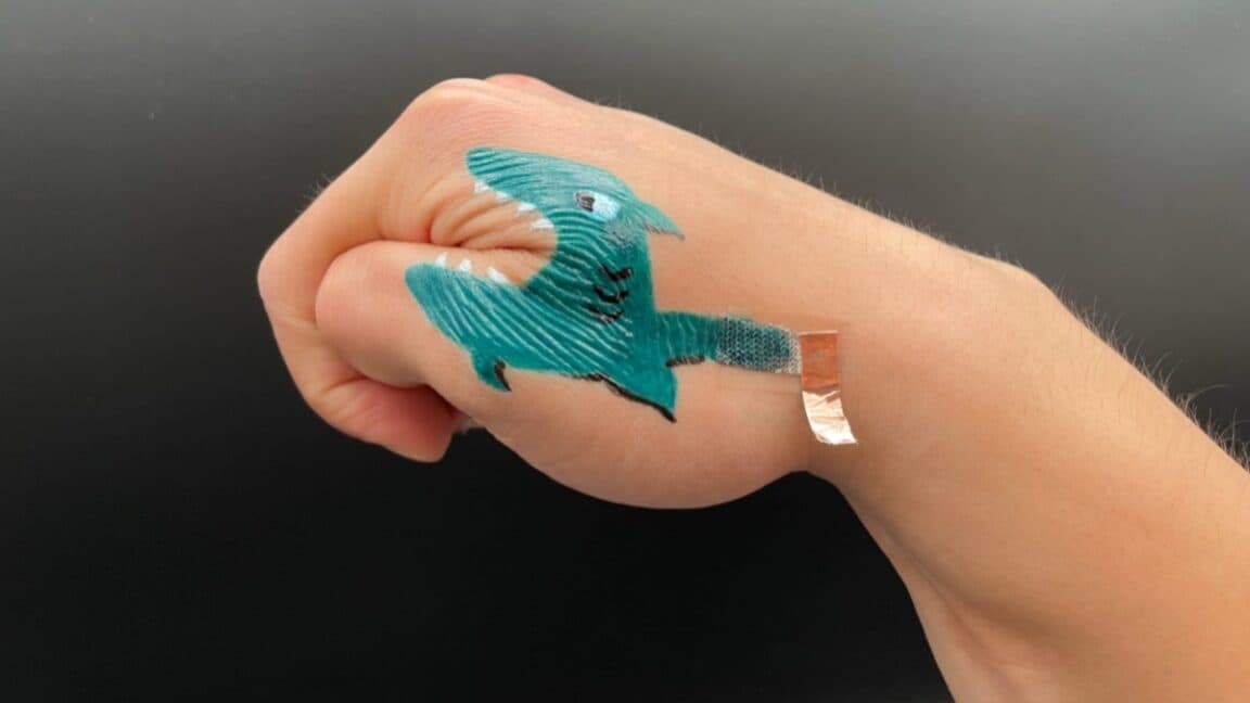 Penn State researchers showcasing painted e-tattoos as innovative health monitoring devices.