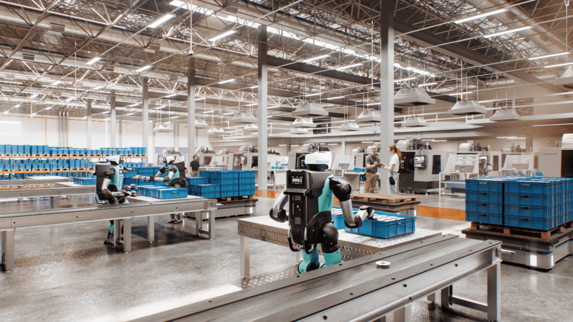 Digit 5 humanoid robot operating safely alongside human workers in a warehouse setting.