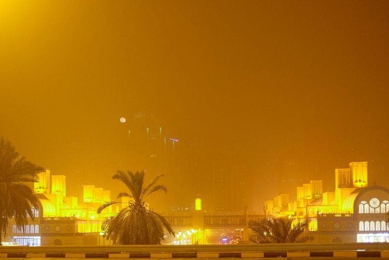 A weather forecast graphic showing high temperatures and dusty conditions in the UAE.