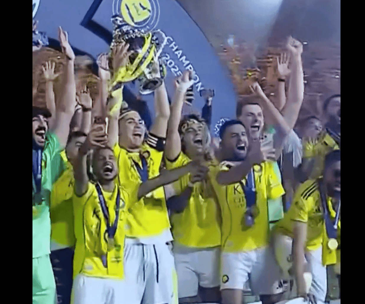 Cristiano Ronaldo celebrating with the Saudi Pro League trophy after scoring two goals for Al-Nassr.