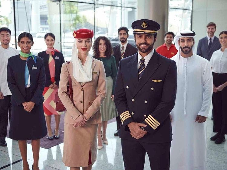Emirates Group employees celebrating the announcement of a salary bonus.