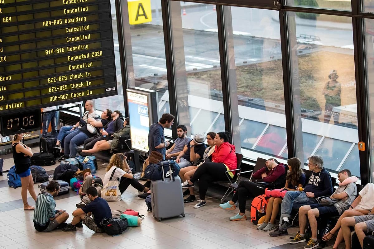 Passengers at an airport affected by flight disruptions due to geopolitical tensions.