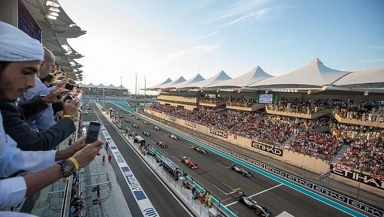 Formula 1 cars racing on a track with a backdrop of geopolitical tension.