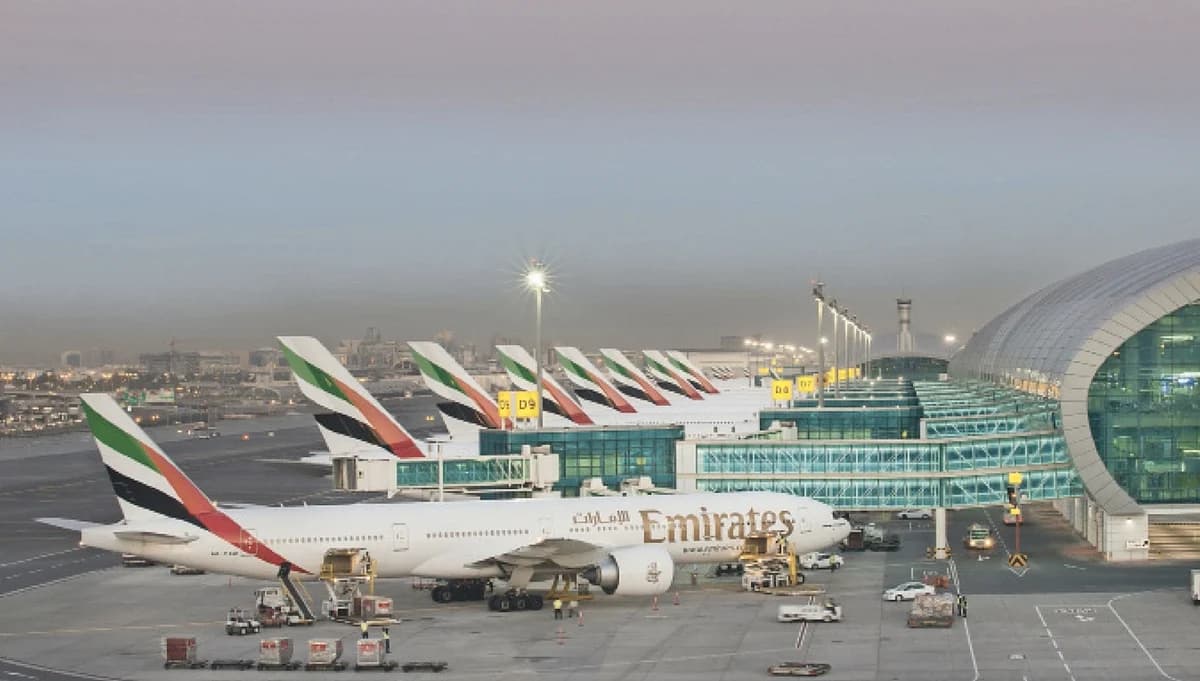 Aerial view of Dubai International Airport bustling with travelers during peak season.
