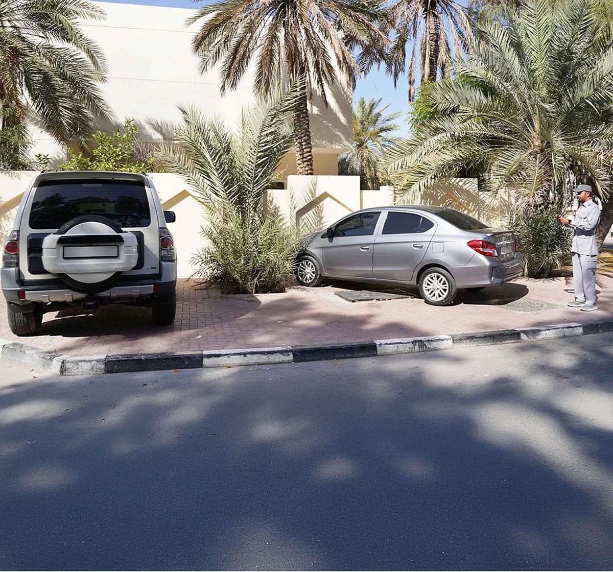 A tow truck removing a vehicle for illegal parking in Dubai.