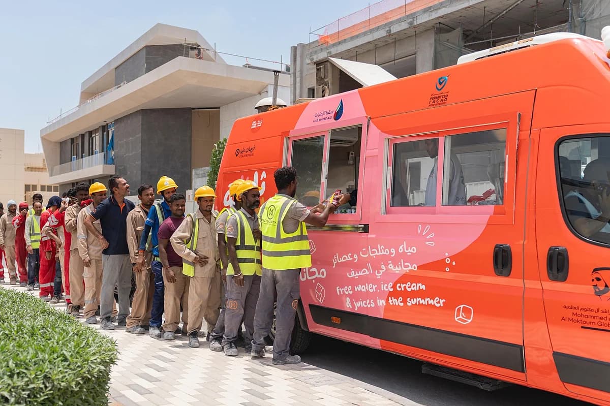 Workers receiving cooling refreshments in the UAE summer heat