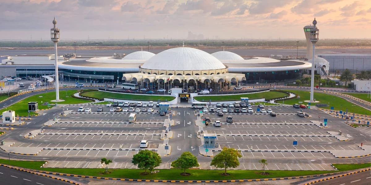 Sharjah Airport bustling with travelers during summer peak season.