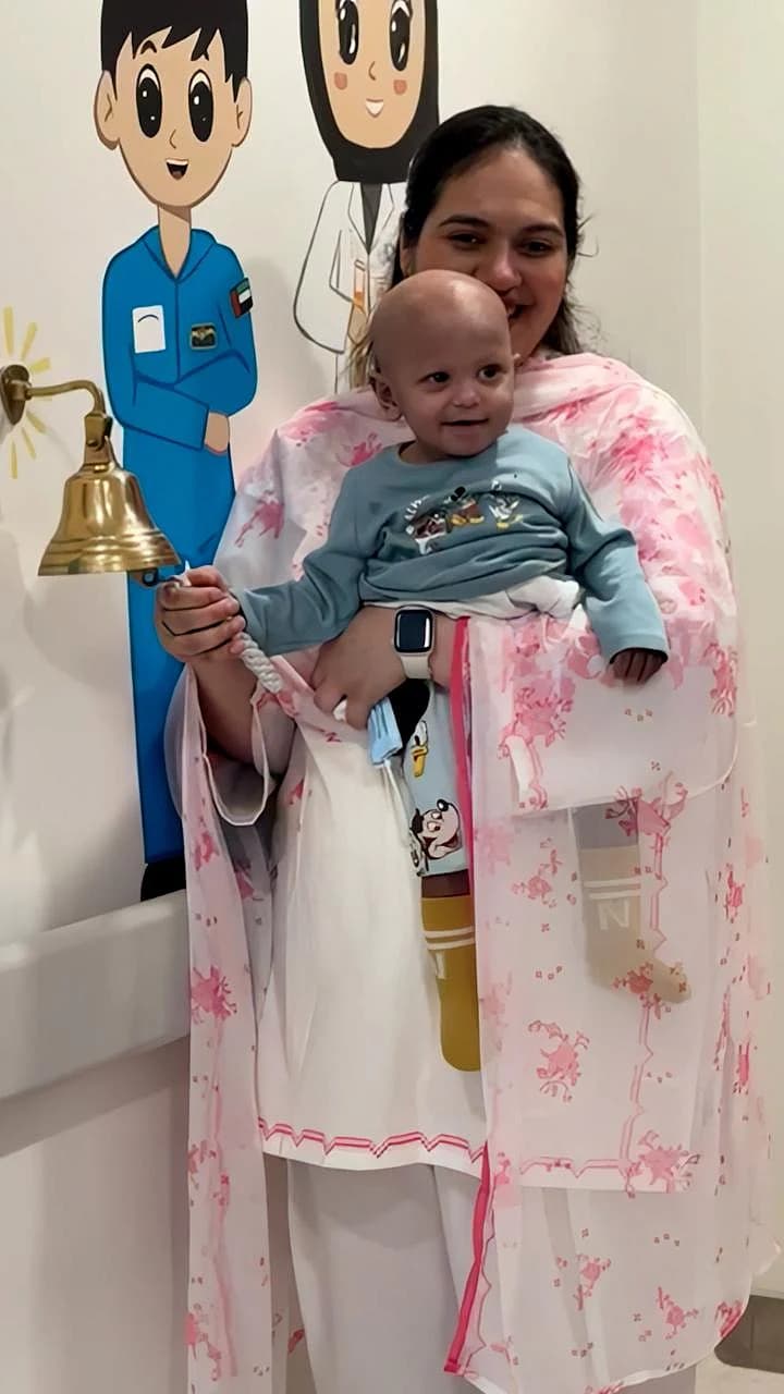 A 13-month-old boy in a hospital bed after a successful bone marrow transplant.