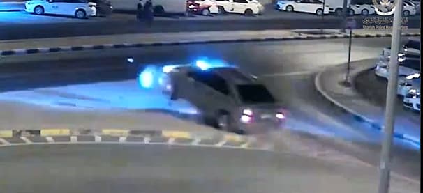 A sedan crashing into a traffic island, illustrating the dangers of distracted driving.