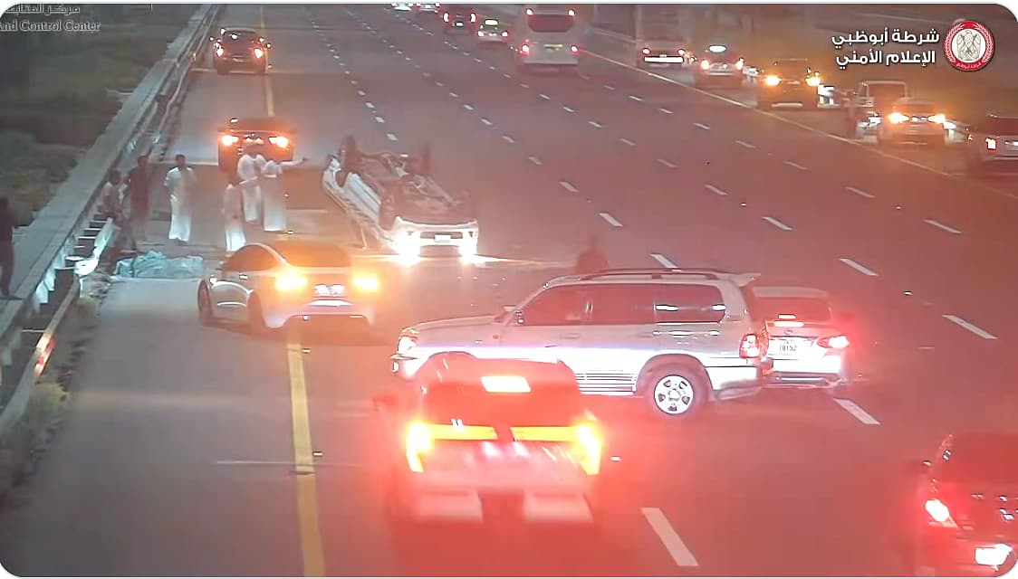 A scene from the Abu Dhabi multi-vehicle crash showing the intervening driver and damaged cars.