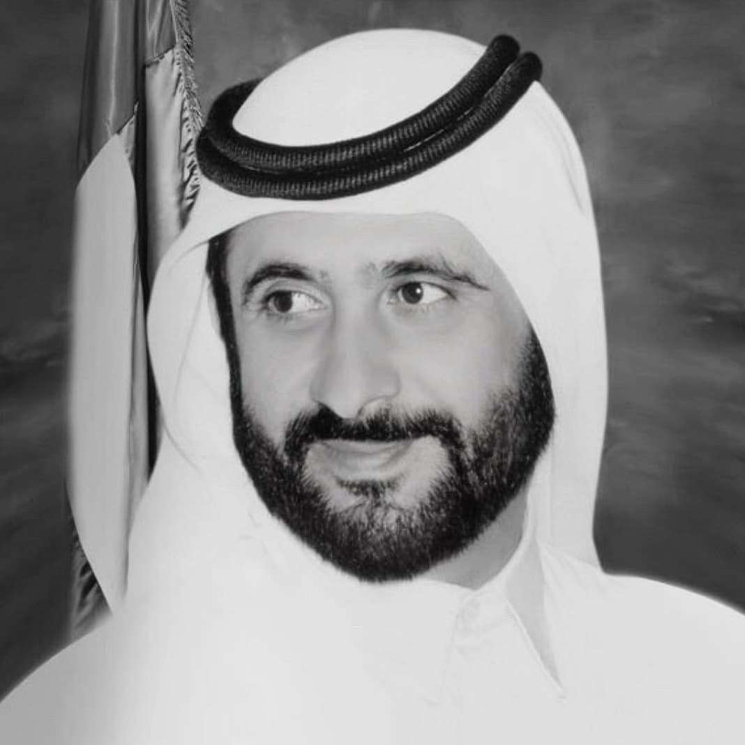 Sheikh Ahmed bin Rashid Al Maktoum with Dubai skyline and flags at half-mast.