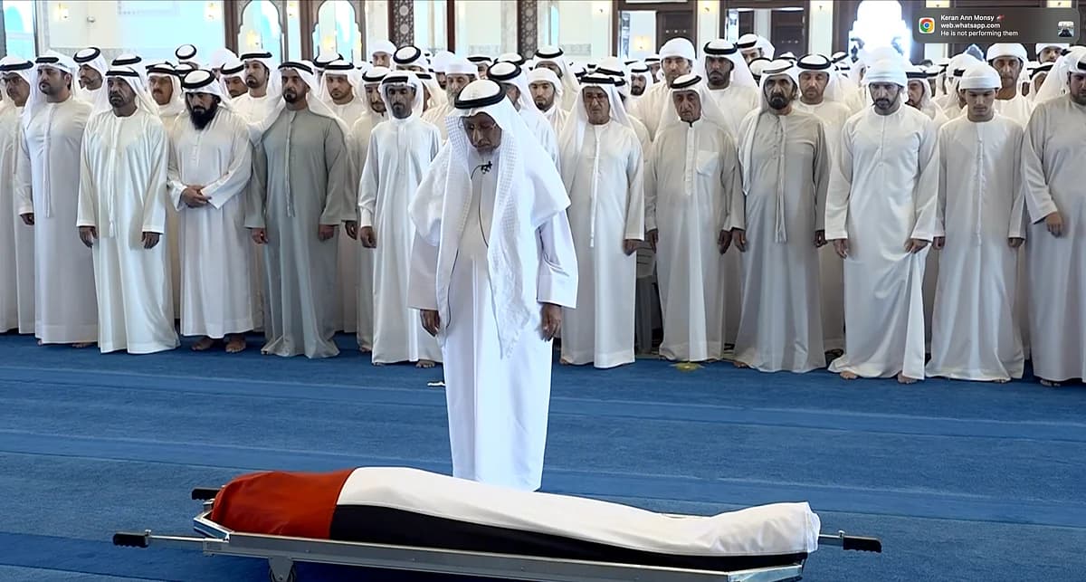 Sheikh Mohammed bin Rashid Al Maktoum leading funeral prayers for Sheikh Ahmed, with UAE flag and royal family present.