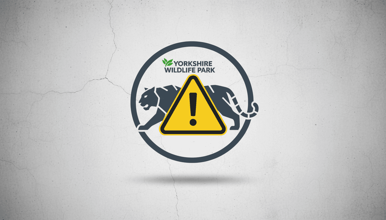 A caution symbol overlaid on the Yorkshire Wildlife Park logo, highlighting the recent tiger enclosure incident.